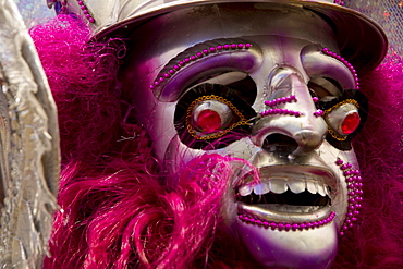 Morenada dancer wearing an elaborate mask and costume in the procession of the Carnaval de Oruro, Oruro, Bolivia