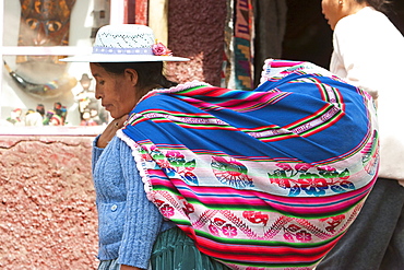 Aymara woman carrying a huge cloth bag on her back, La Paz, Bolivia