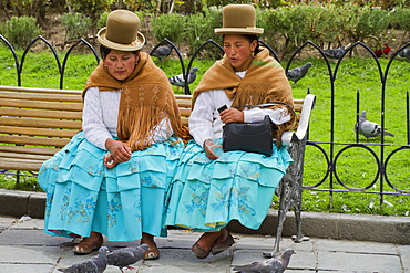 Cholitas sitting on a bench in Plaza Murillo, La Paz, Bolivia