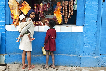 Children at a butcher shop, Antananarivo, Madagascar