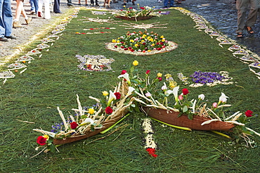 Carpet made of pine needles & flowers along the Good Friday processional route. Carpet-making is thought of as a sacrificial act, as the elaborate detail and time that go into the carpet making is a way for people to give something of themselves in memory of the crucifixion of Jesus. These carpets last on average 2 hours before they are destroyed by the many feet that march over them during a procession in Antigua Guatemala., Sacatepuquez, Guatemala