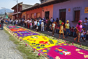 Carpet with Christian imagery made of sand & sawdust along the Good Friday processional route. Carpet-making is thought of as a sacrificial act, as the elaborate detail and time that go into the carpet making is a way for people to give something of themselves in memory of the crucifixion of Jesus. These carpets last on average 2 hours before they are destroyed by the many feet that march over them during a procession in Antigua Guatemala., Sacatepuquez, Guatemala