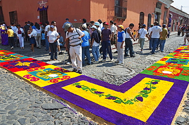 Carpet made of sand & sawdust along the Good Friday processional route. Carpet-making is thought of as a sacrificial act, as the elaborate detail and time that go into the carpet making is a way for people to give something of themselves in memory of the crucifixion of Jesus. These carpets last on average 2 hours before they are destroyed by the many feet that march over them during a procession in Antigua Guatemala., Sacatepuquez, Guatemala