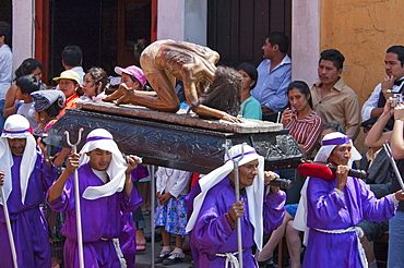 Man carrying the anda (float) of the Whipped Christ during the Procession of the Holy Cross on Good Friday in Antigua Guatemala, Sacatepuquez, Guatemala