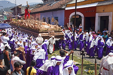 Men carrying the anda (float) of Jesus carrying the Cross during the Procession of the Holy Cross on Good Friday in Antigua Guatemala, Sacatepuquez, Guatemala