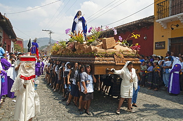 Women dressed in mourning carry the anda (float) of the Virgin Mary during the Procession of the Holy Cross on Good Friday in Antigua Guatemala, Sacatepuquez, Guatemala