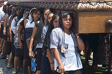 Women dressed in mourning carry the anda (float) of the Virgin Mary during the Procession of the Holy Cross on Good Friday in Antigua Guatemala, Sacatepuquez, Guatemala