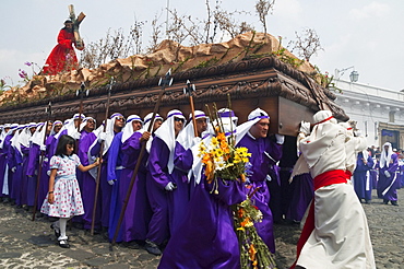 Men carrying the anda (float) of Jesus carrying the Cross during the Procession of the Holy Cross on Good Friday in Antigua Guatemala, Sacatepuquez, Guatemala