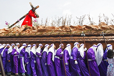 Men carrying the anda (float) of Jesus carrying the Cross during the Procession of the Holy Cross on Good Friday in Antigua Guatemala, Sacatepuquez, Guatemala