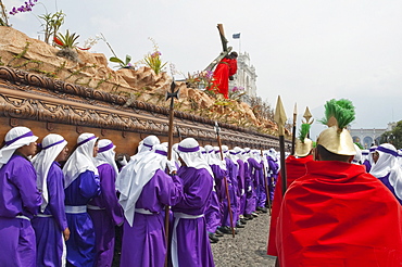 Men carrying the anda (float) of Jesus carrying the Cross during the Procession of the Holy Cross on Good Friday in Antigua Guatemala, Sacatepuquez, Guatemala