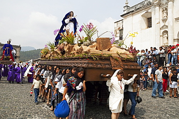 Women dressed in mourning carry the anda (float) of the sorrowful Virgin Mary during a Good Friday Procession in Antigua Guatemala, Sacatepuquez, Guatemala