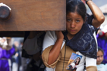 Woman dressed in mourning helps carry the anda (float) of the sorrowful Virgin Mary during a Good Friday Procession in Antigua Guatemala, Sacatepuquez, Guatemala