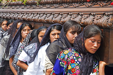 Women dressed in mourning carry the anda (float) of the sorrowful Virgin Mary during a Good Friday Procession in Antigua Guatemala, Sacatepuquez, Guatemala