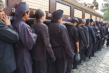 Men carrying the anda (float) of Jesus Christ after the Crucifixion leave the Cathedral for the Holy Burial Procession on Good Friday in Antigua Guatemala, Sacatepuquez, Guatemala