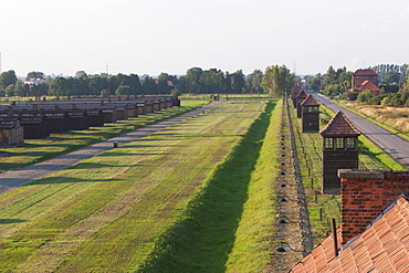 View of the watchtowers along the camp perimeter from the main guard house (Gate of Death), Auschwitz-Birkenau Concentration Camp, Oswiecim, Malopolska, Poland