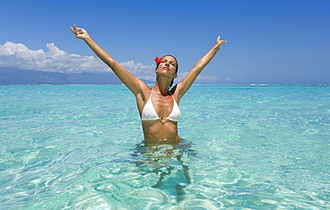 Woman standing in tropical ocean water.