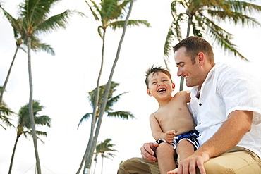 Hawaii, Oahu, A happy father interacting with his son.