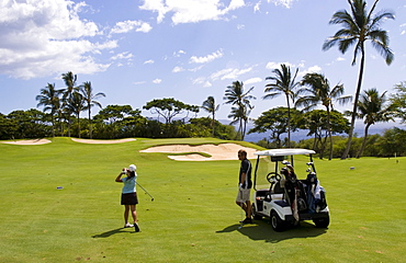 Hawaii, Maui, Wailea, Female golfer on golf course.