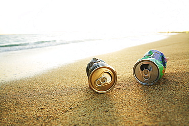 Hawaii, Oahu, Aluminum cans on the beach.