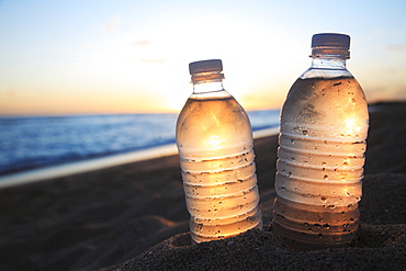 Hawaii, Oahu, Bottle of water on the beach.