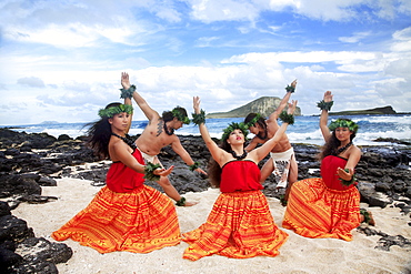 Hawaii, Oahu, Makapu'u Beach, Group of Tahitian Male and Female Dancers posing, Rabbit Island in background.