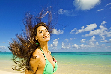 Hawaii, Oahu, Lanikai, Beautiful woman jumping in the air.