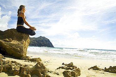 Hawaii, Kauai, Mahaulepu, Woman doing yoga.