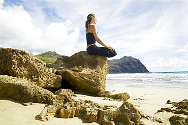 Hawaii, Kauai, Mahaulepu, Woman doing yoga.