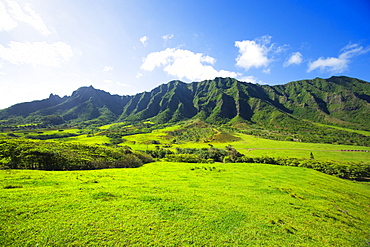 Hawaii, Oahu, View of Kaaawa valley and Kualoa Ranch with the Koolau Mountain range in background.