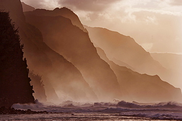 Hawaii, Kauai, North Shore, Na Pali Coast, Haena, Misty waves at dusk.