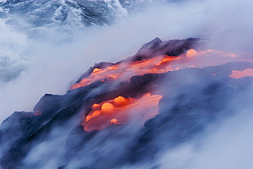 Hawaii, Big Island, near Kalapana, View from above of smoking pahoehoe lava flow into Pacific Ocean.