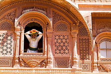 India, Rajasthan, Jodhpur, Fort Mehrangarh, man in window of Fort Palace.