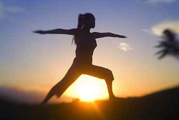 Hawaii, Maui, Olowalu, woman doing yoga at sunset.