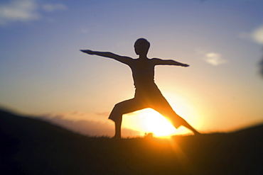 Hawaii, Maui, Olowalu, woman doing yoga at sunset.