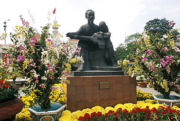 Vietnam, Ho Chi Minh City (Saigon), Uncle Ho statue in city center, surrounded by flowers.