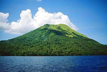 Papua New Guinea, Rabaul, The Mother Volcano, green mountainside with ocean and clouds