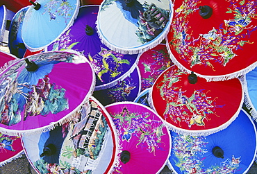 Thailand, Nakhon Pathom, detail of many colorful handpainted umbrellas overlapping