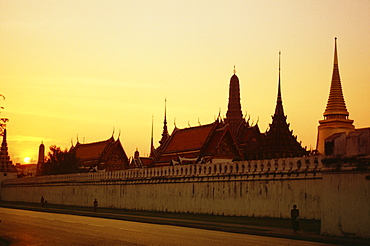 Thailand, Bangkok, Royal Palace complex seen from outside gate at sunrise