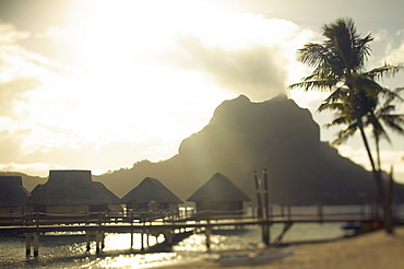 French Polynesia, Tahiti, Bora Bora, Mount Otemanu and overwater bungalows at sunrise