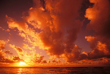 Hawaii, Kauai, Wailua, Sunrise over the ocean on a cloudy morning.