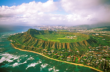 Hawaii, Oahu, Aerial of Diamond Head Crater with coastline view, Kahala homes foreground and Waikiki hotels background