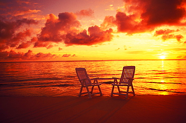 Hawaii, Oahu, Lanikai beach at sunrise with beach chairs in shoreline water