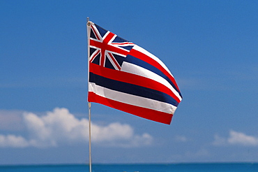 Hawaii, Hawaiian Flag, blue sky and clouds, ocean and horizon in foreground