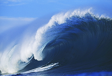 Hawaii, Oahu, North Shore, Pipeline, big blue wave curling with mist blowing off tip