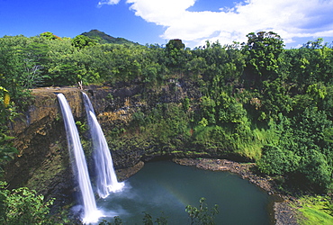 Hawaii, Kauai, Wailua Falls, 80 foot high waterfall cascading into deep pool.