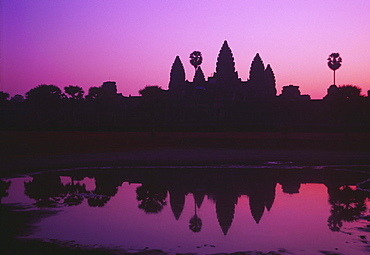 Cambodia, Angkor Wat, Silhouette of temple at sunrise.