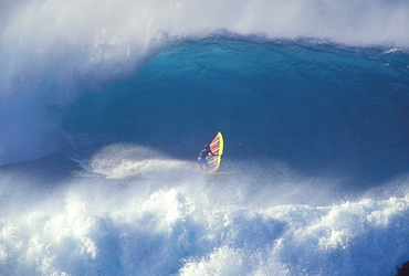 Hawaii, Maui, Jason Polakow in midst of huge crashing waves, one curls above, action