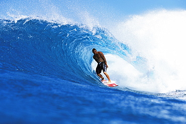 Hawaii, Oahu, North Shore, Backdoor Pancho stands inside wave curl