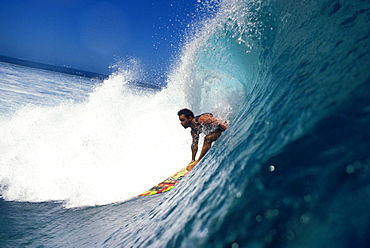 Surfer Johnny Boy Gomez, surfs a wave close-up side angle, whitewash background