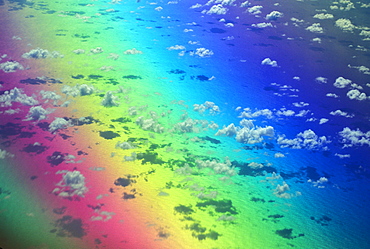 Polarized rainbow and aerial of clouds over the ocean